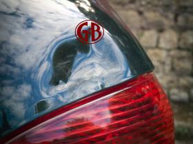 Mercedes car deeply dented trunk lid needing auto body shop dent repair work