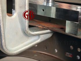 Auto body shop frame machine straightening a truck frame from an auto accident